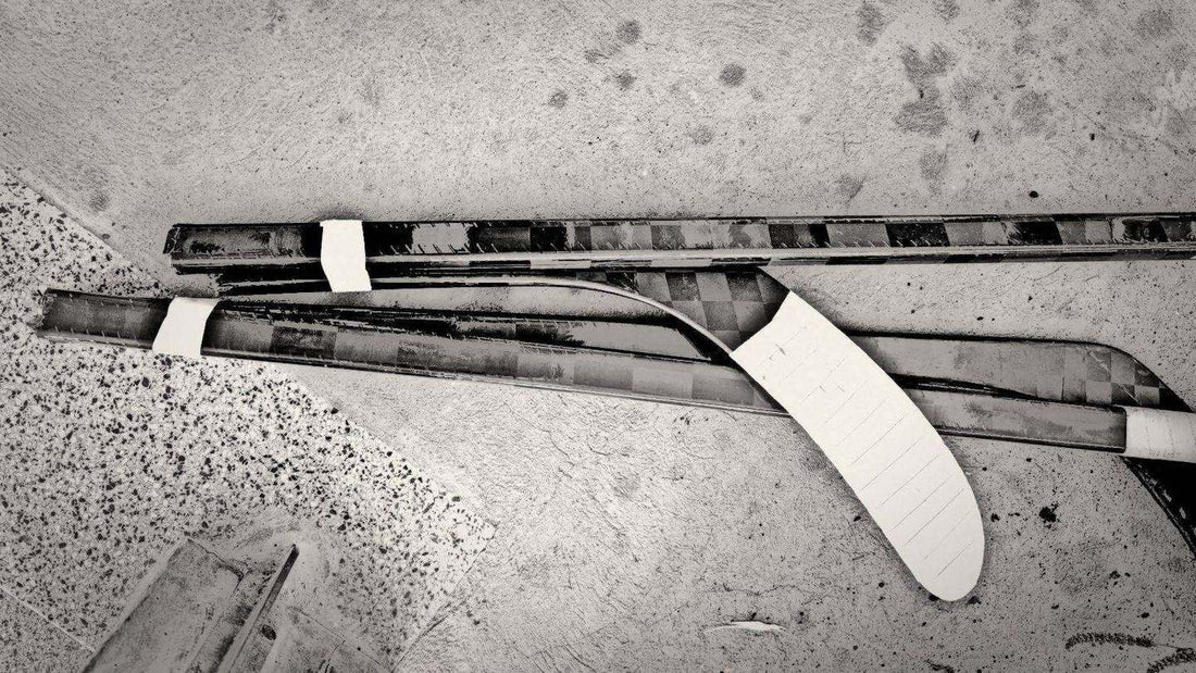 Charcoal-style sketch of a broken carbon ice hockey stick lying on a concrete floor