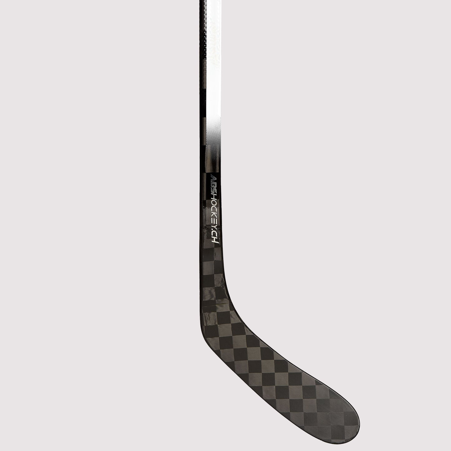 Lower shaft and blade detail of the NSC hockey stick with double concave taper, carbon finish and subtle NSC branding.