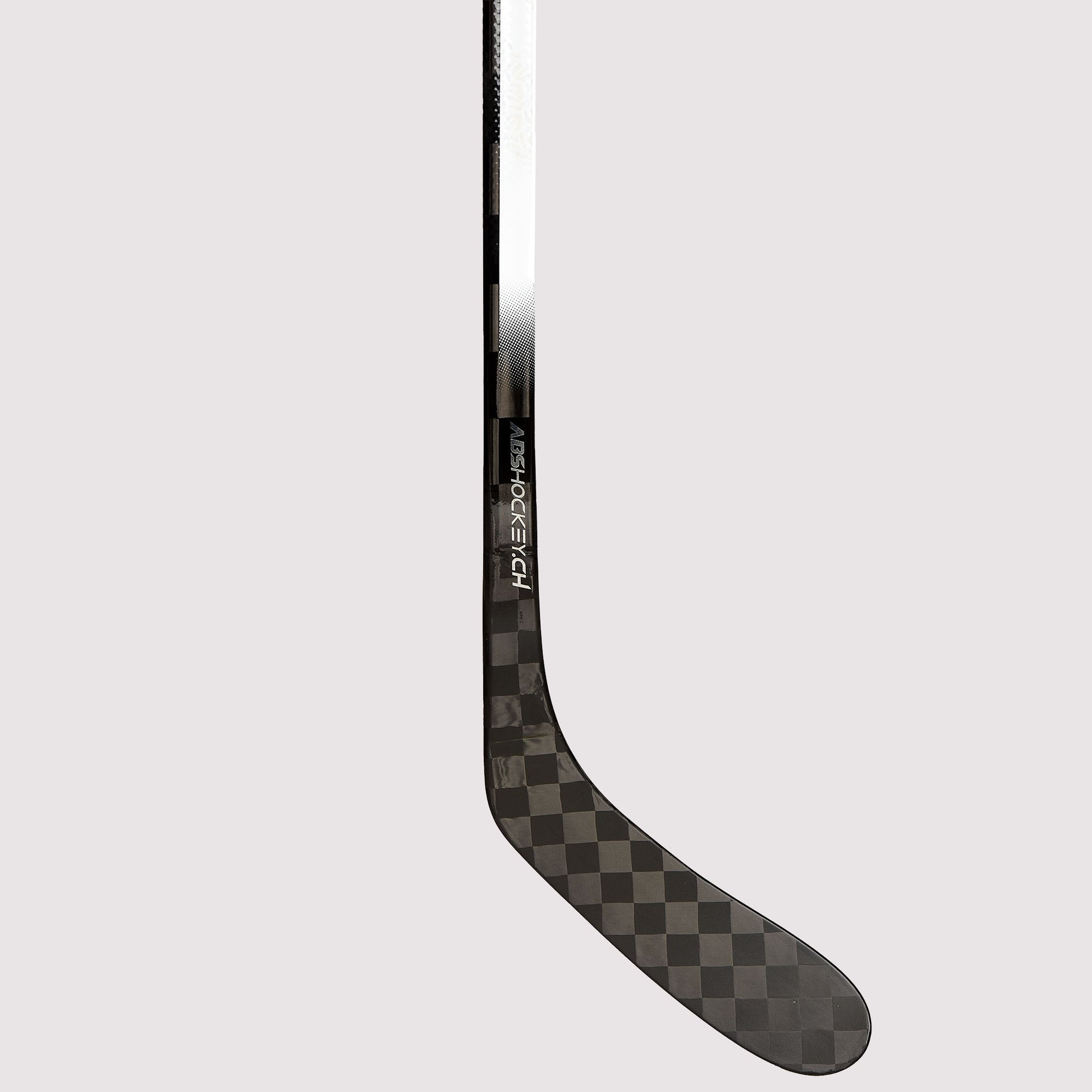 Lower shaft and blade detail of the NSC hockey stick with double concave taper, carbon finish and subtle NSC branding.