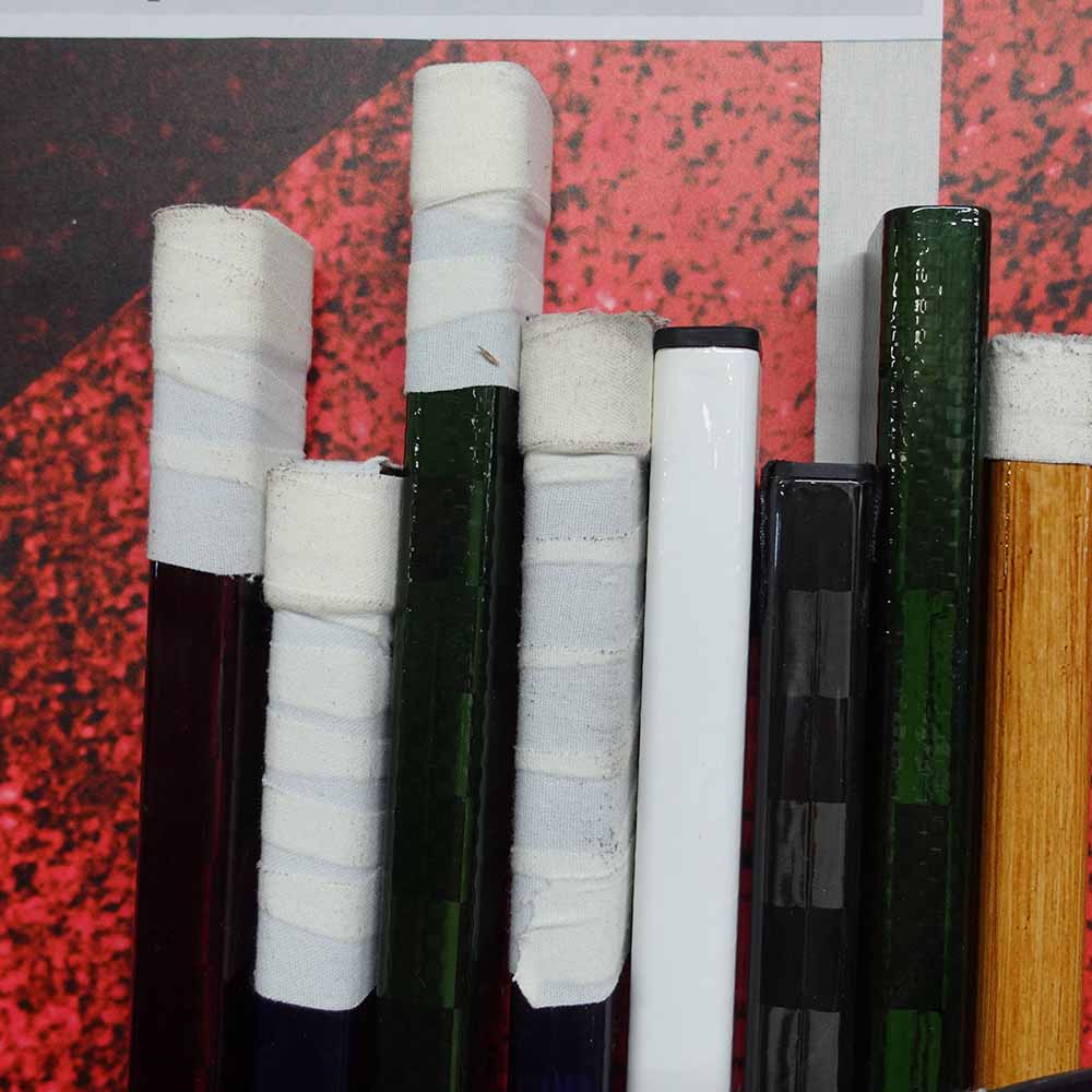 Ice hockey stick knob with different tape jobs in white ice hockey tape