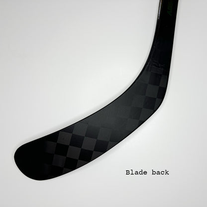 Ice hockey stick blade A90TM as well as A92 similar to P90TM and P92 of bauer. Background is white. Text in the picture is "Blade back". The carbon pattern of the blade is clearly visible. It is a close up of only the blade of the ice hockey stick. The stick is named lunar 1.0 and is highest quality on the market.