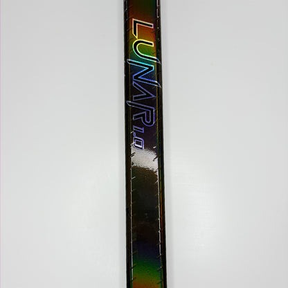 ice hockey stick shaft part with the lunar 1.0 logo saying "lunar 1.0" shining in rainbow colors like red, yellow, green and the normal color which is brown. The spiral grip on the edges of the stick is clearly visible. It is a close up of an ice hockey stick shaft.