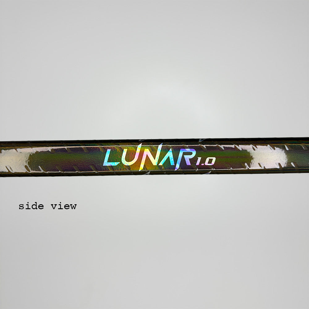 close-up of the ice hockey stick lunar 1.0 with a view on the side part of the stick. You can see the logo "lunar 1.0" and reflections on the stick since it's a solid shiny grip. Also you can see the spiral grip and the backgorund is white. There is a written part saying "side-view" in the picture.